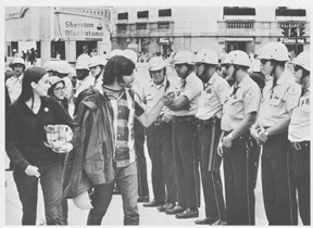 Protester in Chicago mocking a line of policemen.