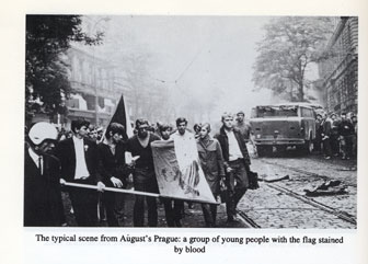 Group of Czech students marching through the street holding a bloody flag.